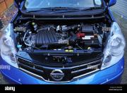under-the-bonnet-close-up-of-a-blue-nissan-note-hatchback-motor-car-BGR70D.jpg